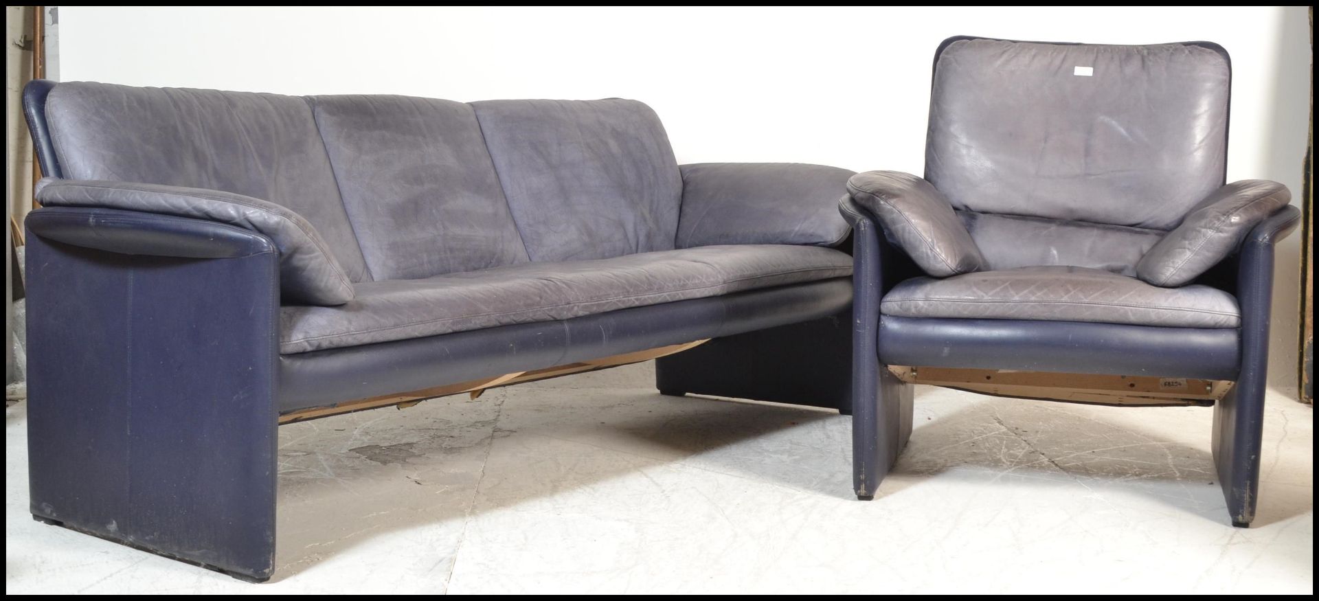 A 20th Century vintage Leolux lounge suite consisting of a three seater sofa and armchair , the body