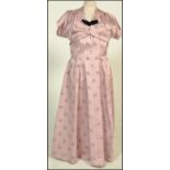 A vintage 1950's ladies two piece pleated A - Line dress and cap sleeve jacket with label Country