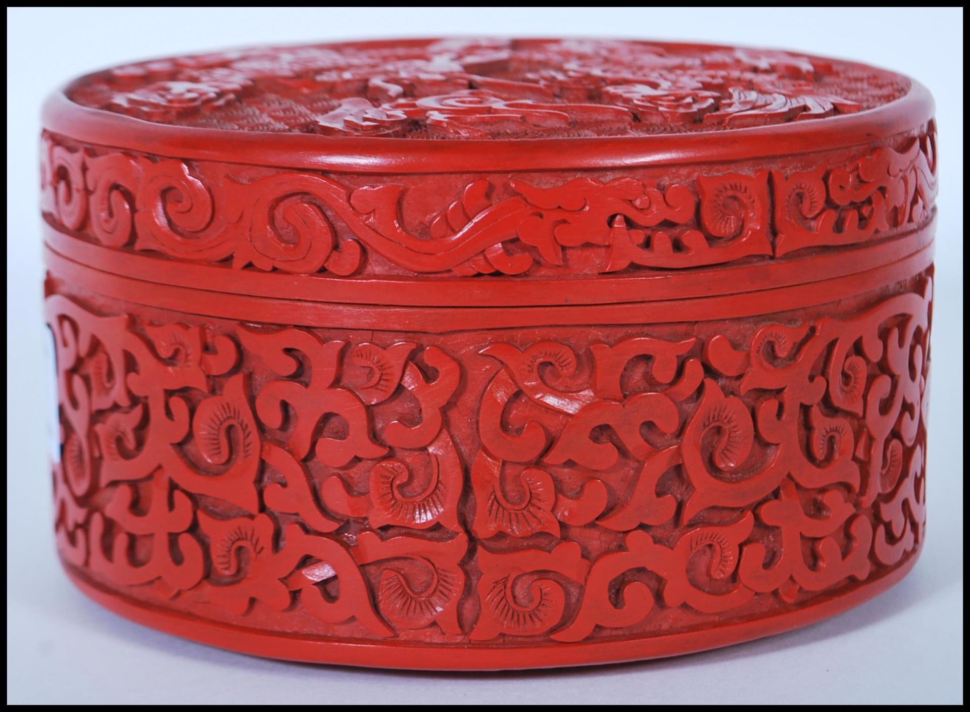 A 20th Century Chinese Cinnabar round desk top box of round form having carved relief of a Chinese - Image 3 of 7