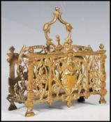 A 19th Century Victorian brass letter rack decorated with cherub masks and pierced scroll work