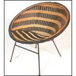 A mid century, circa 1950's satellite chair raised on tubular metal frame with two tone weave bucket