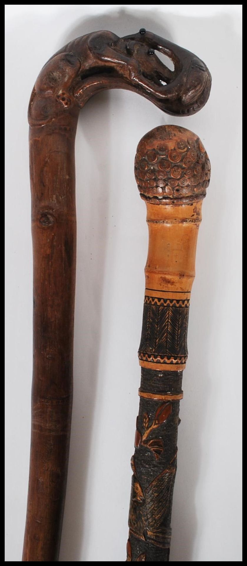 A 20th Century carved bamboo Japanese style walking stick cane decorated with carved blossoms and