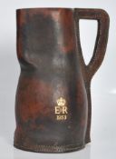 A vintage mid 20th Century commemorative leather blackjack drinking tankard / ewer jug having gilt