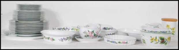 A large 20th Century Royal Worcester dinner service in the Herbs pattern, each piece being decorated