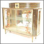 A vintage retro mid 20th Century Kitsch cocktail / display cabinet, glazed floral printed sliding