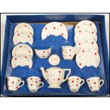 A mid 20th Century child's decorated pottery tea service by Ellar, four cups with saucers, side