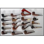 A good collection of vintage smoking tobacco pipes to include a leather case example having a