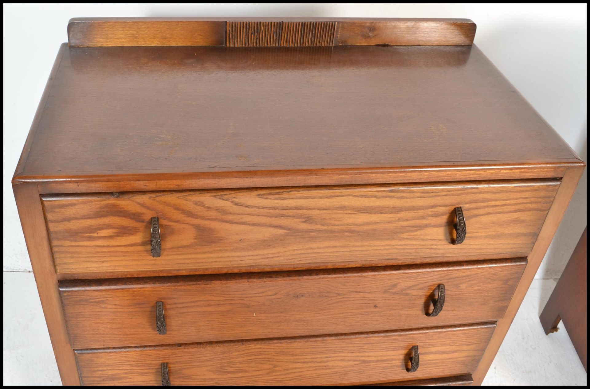 A 1930's Art Deco oak chest of drawers being raised on bracket feet with a  bank of 4 drawers having - Image 7 of 9