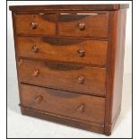 A Victorian 19th century mahogany chest of drawers being raised on bun feet with 2 short over 3 deep