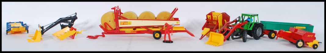 A COLLECTION OF BRITAINS FIRST FARMYARD VEHICLES AND ACCESSORIES.