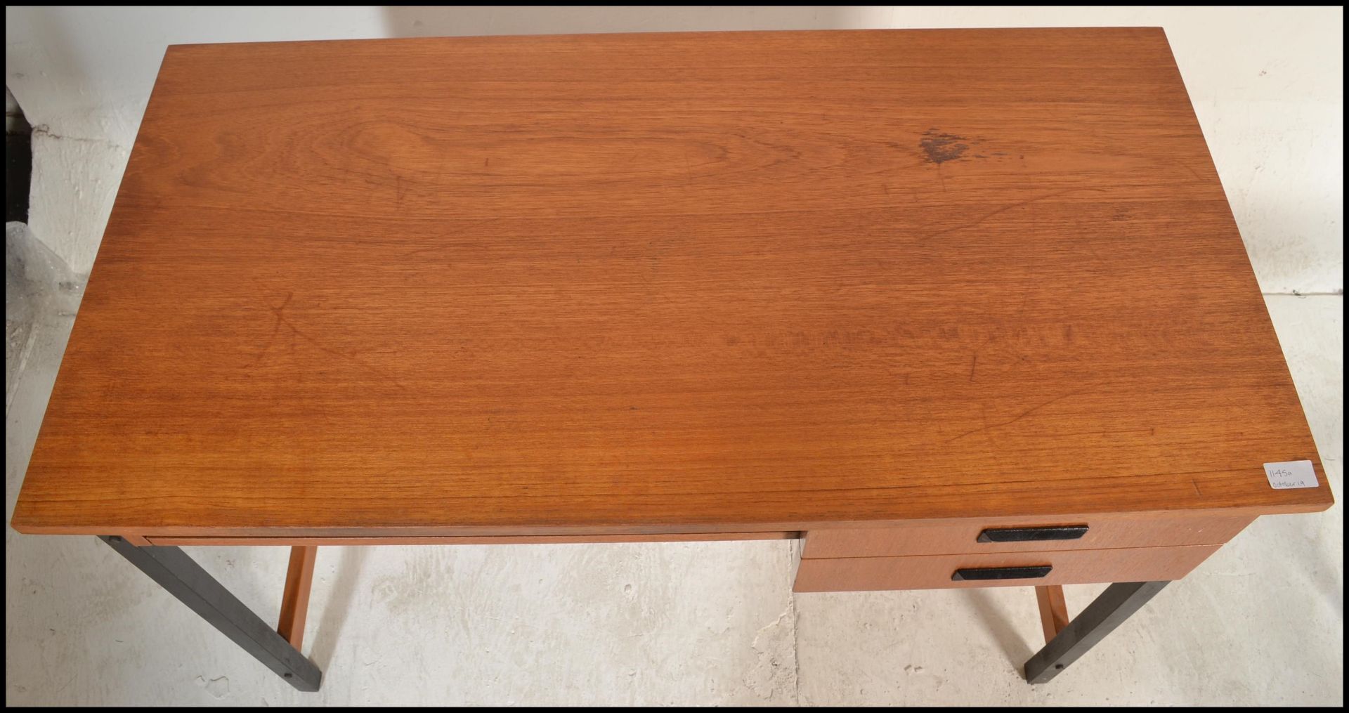 A 20th Century retro teak wood desk, raised on tubular black metal supports, two drawers to the - Bild 2 aus 6
