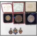 A collection of Bristol local interest medals awarded to a J Hearle to include three silver fob
