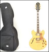 Musical Instruments: A Gibson electric Epiphone six string guitar having a shaped wooden lacquer