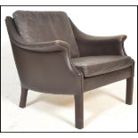 A late 20th century retro vintage Danish easy lounge chair / armchair having dark brown leather