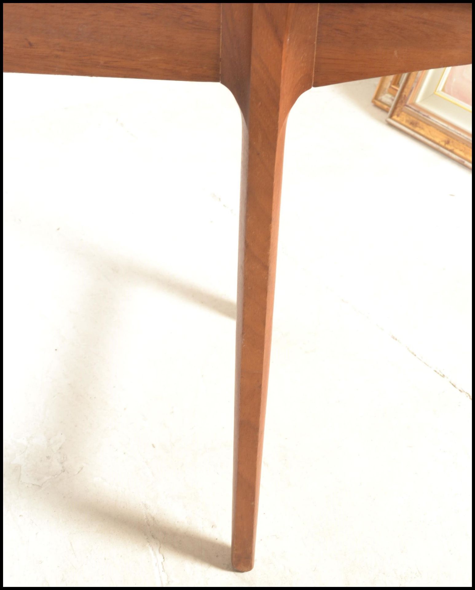 A mid century Bath Cabinet Makers teak wood Danish inspired dining table being raised on turned, - Image 5 of 7