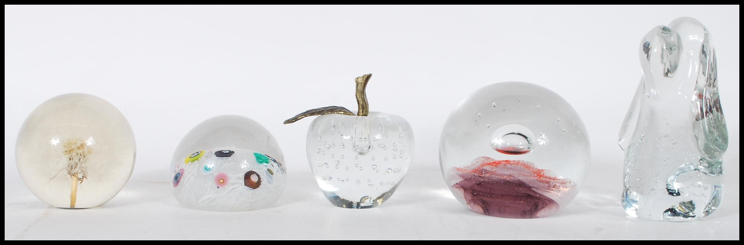 A collection of glass paperweights to include a limited edition paperweight by Caithness titled