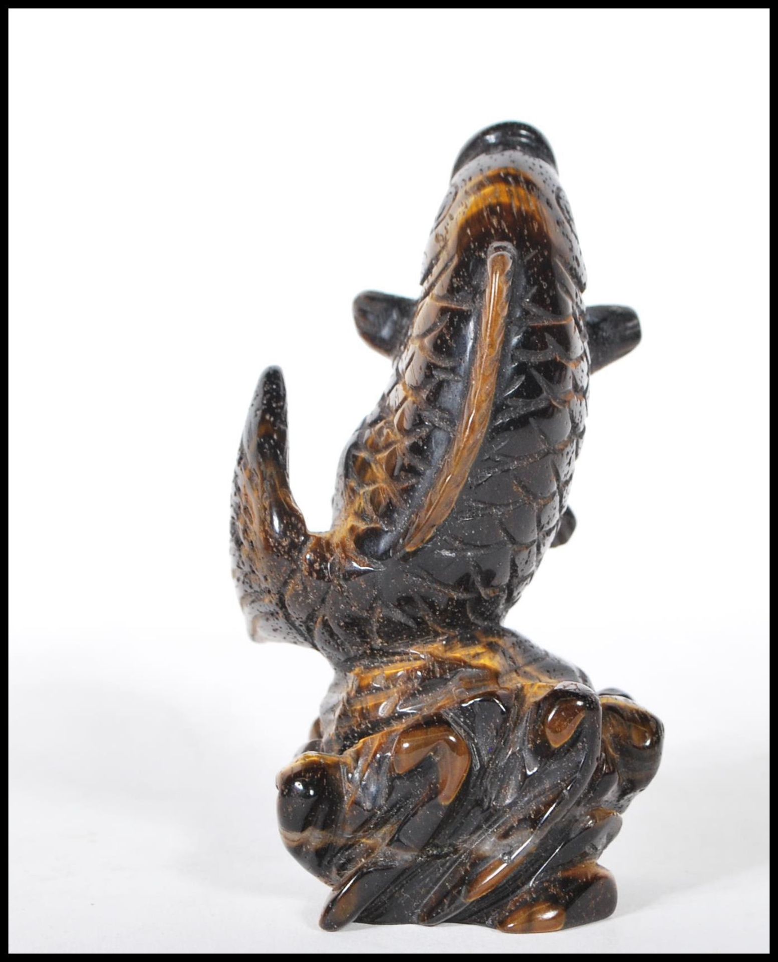 A 20th Century Chinese carved tigers eye ornament in the form of a koi carp fish jumping from the - Bild 2 aus 6