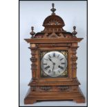 A late 19th / early 20th Century walnut cased brass faced eight day mantel clock, the case of