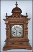 A late 19th / early 20th Century walnut cased brass faced eight day mantel clock, the case of