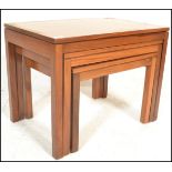 A retro mid 20th Century teak wood nest of three tables of square form. Biggest measures 46cm tall
