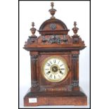 An early 20th century Hamburg America Clock Company walnut cased mantel clock, the arched shell