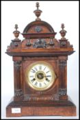 An early 20th century Hamburg America Clock Company walnut cased mantel clock, the arched shell
