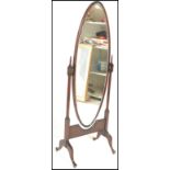 A 20th Century mahogany framed Cheval dressing bedroom mirror, the oval framed bevelled mirror