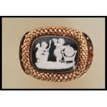 A Regency gold clasp having a central glazed panel with a sulphide panel depicting cherubs