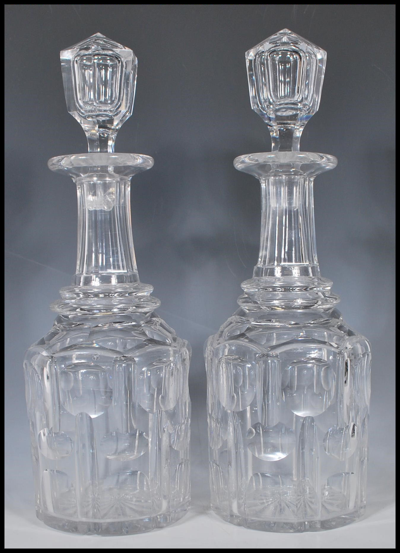 A matching pair of 19th Century Victorian cut glass decanters. Each one having hollow blown