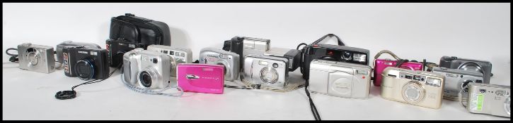 A collection of mostly digital cameras and cases to include makes and models from Nikon Coolpix