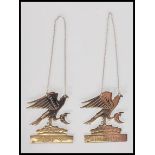 A pair of silver hallmarked drinks labels for Gin and Port, the labels modelled as eagles in