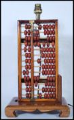 A retro mid 20th Century 1960's table lamp in the form of a Chinese abacus of typical beaded form,