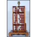 A retro mid 20th Century 1960's table lamp in the form of a Chinese abacus of typical beaded form,