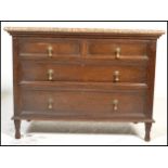 An early 20th Century Jacobean revival oak chest of drawers having a configuration of two short