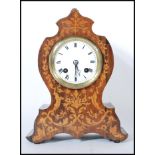 An early 20th Century mahogany cased balloon mantel clock having a mahogany case inlaid with satin