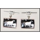 A pair of stamped 925 silver cufflinks having enamelled panels depicting dogs. Gross weight 10.3g.