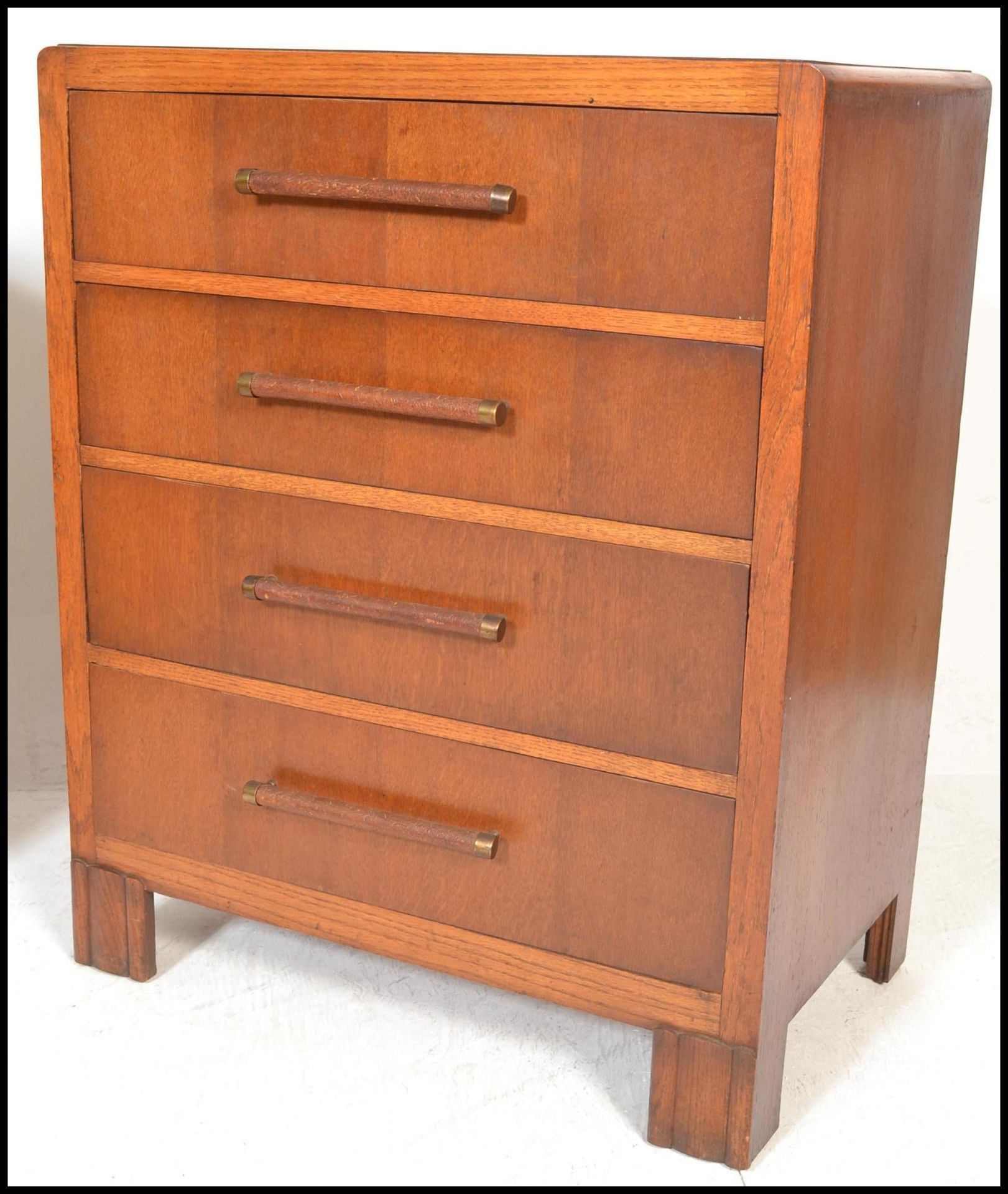 A 1930's Art Deco oak chest of drawers being raised on bracket feet with a  bank of 4 drawers having - Image 3 of 9