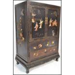 A 20th Century Japanese black lacquer and shibayama two door floor standing cabinet, of