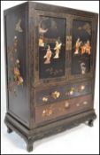 A 20th Century Japanese black lacquer and shibayama two door floor standing cabinet, of