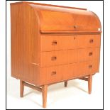 A retro 20th Century Teak wood barrel top bureau having a fully appointed interior over drawers