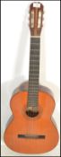 A vintage retro 20th Century six string Spanish made acoustic guitar with paper label inset to the
