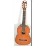 A vintage retro 20th Century six string Spanish made acoustic guitar with paper label inset to the