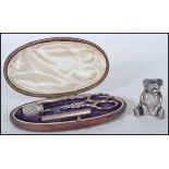 A 20th Century silver sewing kit set within an oval leatherette box with a velvet lined interior