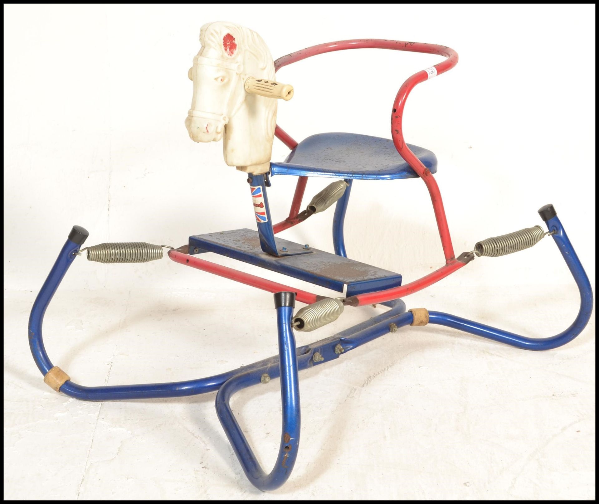 A vintage / retro mid century childs  tin plated Triang rocking horse set on springs on a tubular