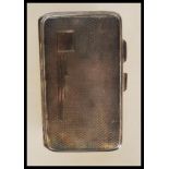 A silver hallmarked cigarette case with engine turned decoration and plain cartouche. Hallmarked for