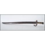 A French 19th century 'Chassepot' pattern 1874 rifle bayonet and scabbard, having a brass ribbed