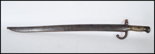 A French 19th century 'Chassepot' pattern 1874 rifle bayonet and scabbard, having a brass ribbed