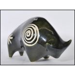 A 1960's retro vintage studio art pottery figurine ornament in the shape of a bull in the manner