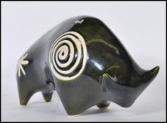 A 1960's retro vintage studio art pottery figurine ornament in the shape of a bull in the manner