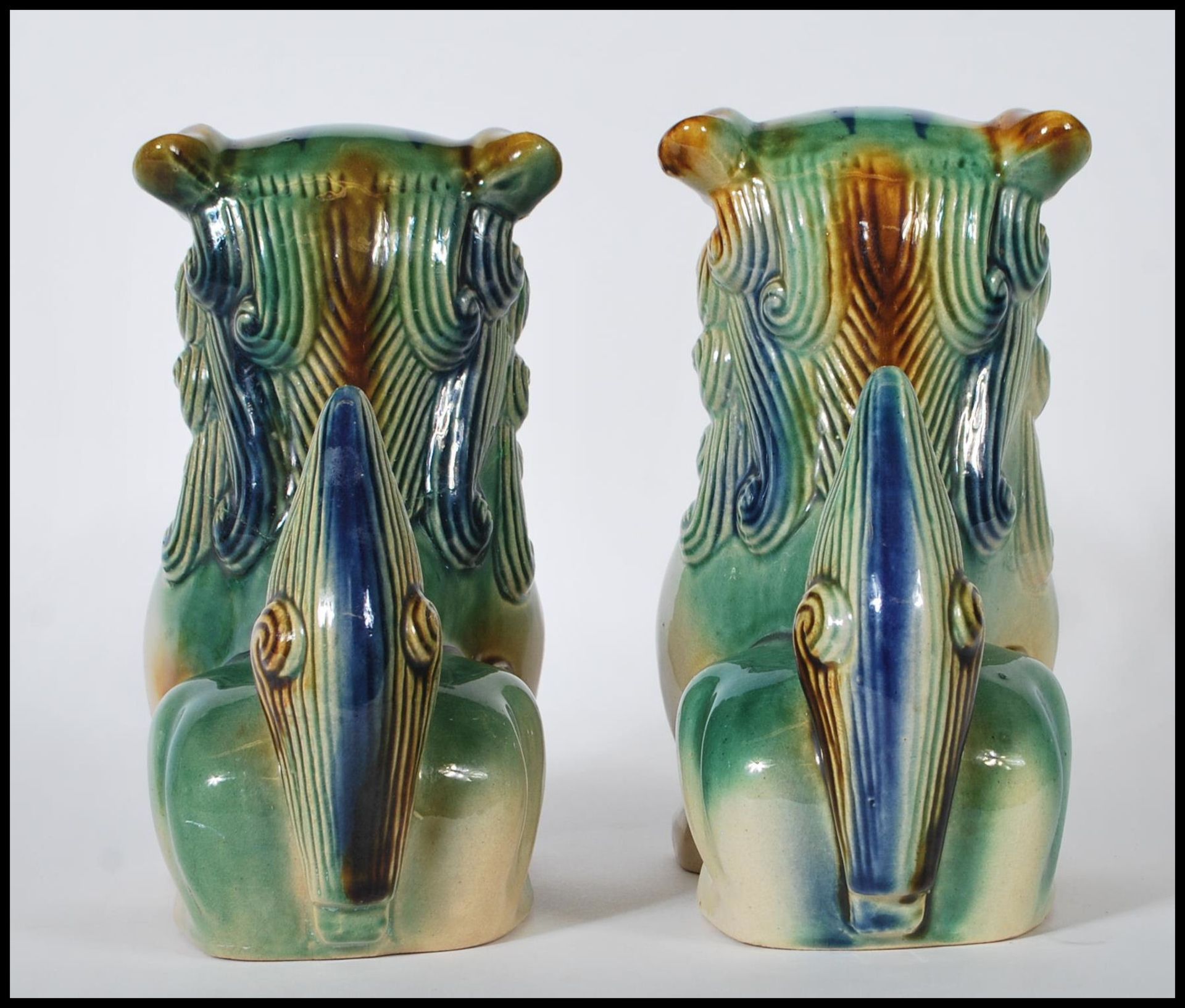 A pair of mid 20th Century Chinese porcelain temple lions / dogs of  Fu. Both modeled with a jade - Image 3 of 6